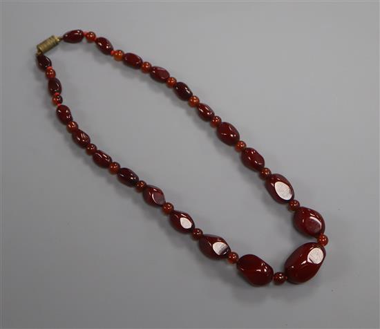 A single strand graduated simulated cherry amber bead necklace, gross weight 25 grams, 42cm.